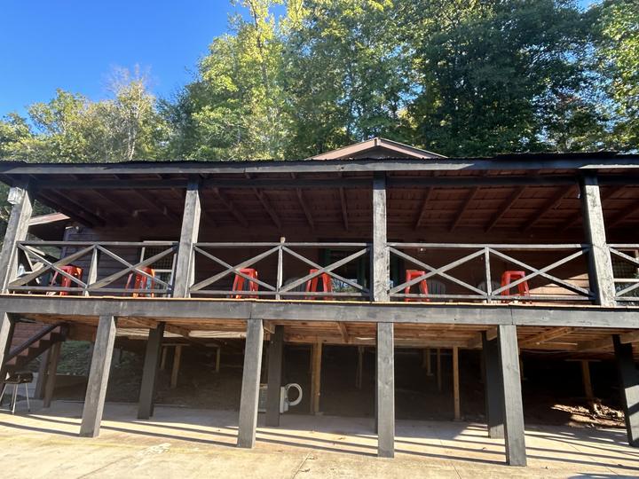 The long upstairs porch of the Hillbilly Hilton, orange stools along the rail