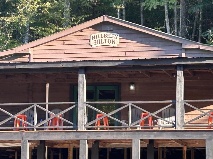 Close-up of the Hillbilly Hilton sign on the gable above the porch